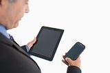Businessman holding smartphone and tablet pc