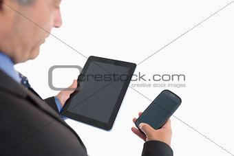 Businessman holding smartphone and tablet pc