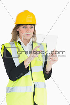 Female architect pressing something on a pane