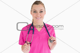 Smiling woman holding her stethoscope