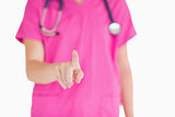 Doctor in pink scrubs pointing at something