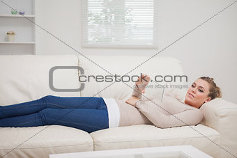 Woman relaxing on the couch while holding a pane