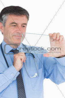 Smiling doctor viewing glass slide