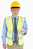 Man in helmet and vest holding a plan