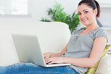 Young woman using a laptop on the couch