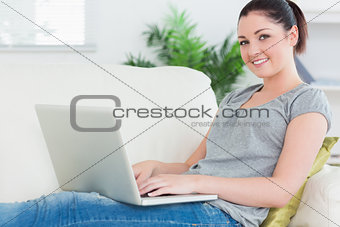 Young woman using a laptop on the couch
