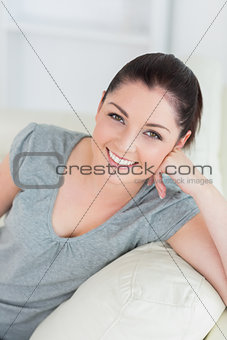 Happy woman sitting on a couch