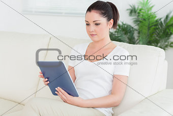 Woman on the couch using a tablet pc