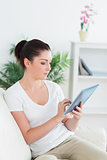 Young woman using a tablet pc on the couch