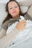Sleeping woman lying on sofa with a cold