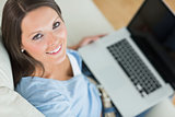 Smiling woman in front of her laptop
