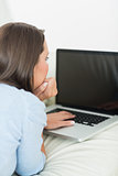 Brunette woman typing on the laptop