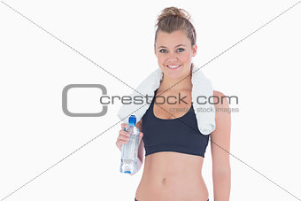 Woman smiling while holding a bottle of water