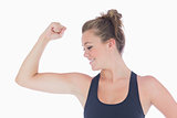Woman standing showing her muscles