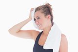 Woman smiling while holding towel at her forehead