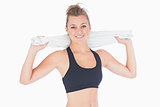Woman standing while holding towel after workout
