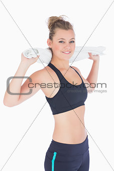 Woman standing holding her towel at her neck in sportswear