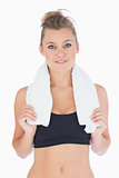 Woman standing while holding a white towel in sportswear