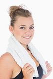 Woman standing and smiling with towel over shoulders