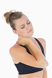 Woman holding hand to stiff neck