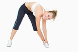 Woman standing while stretching and smiling