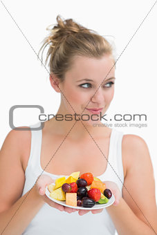 Woman holding a plate of fruit
