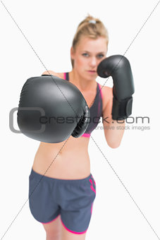 Female boxer stretching arm out