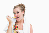 Woman eating fruit and smiling