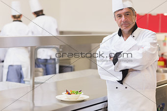 Chef standing beside salad
