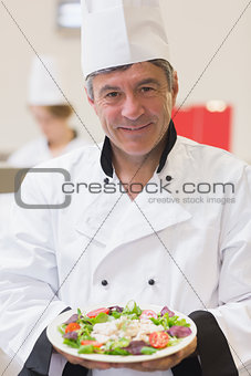 Smiling chef showing his salad