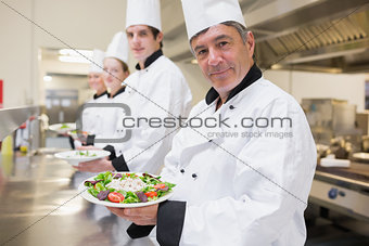 Cheerful Chef's showing their salads