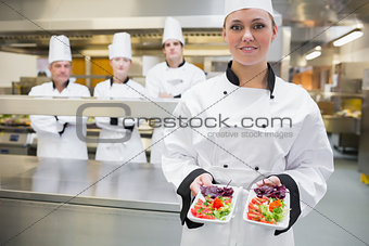 Smiling chef presenting salads