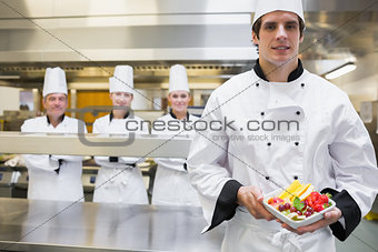 Chef holding fruit salad