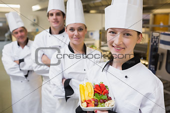 Chef presenting a fruit salad