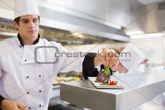 Chef garnishing his cake