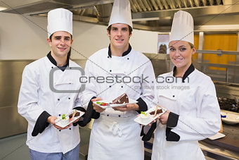 Three Chef's presenting cakes