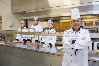 Head chef standing with team behind him