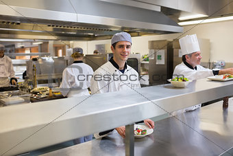 Smiling chef with a salad