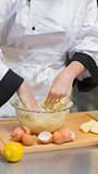Chef mixing dough with hands