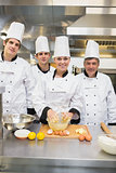 Smiling culinary students with pastry teacher