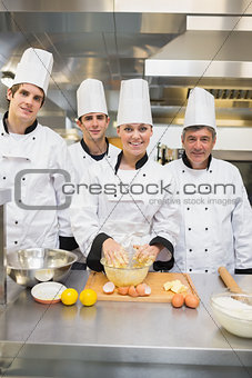 Smiling culinary students with pastry teacher