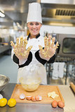 Baker showing her hands with dough