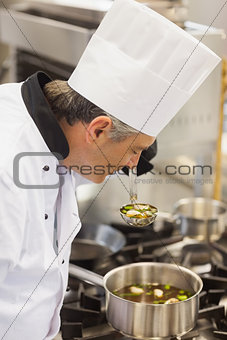 Chef smelling soup