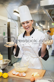 Cheerful chef making dough