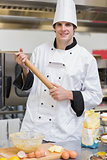 Smiling man holding a rolling pin