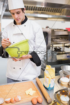 Chef mixing dough with a whisk