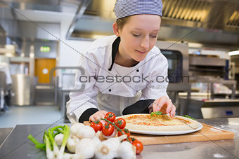 Woman preparing pizza