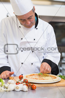 Happy chef making pizza