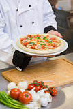 Chef holding mushroom pizza