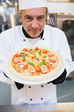 Man presenting a pizza